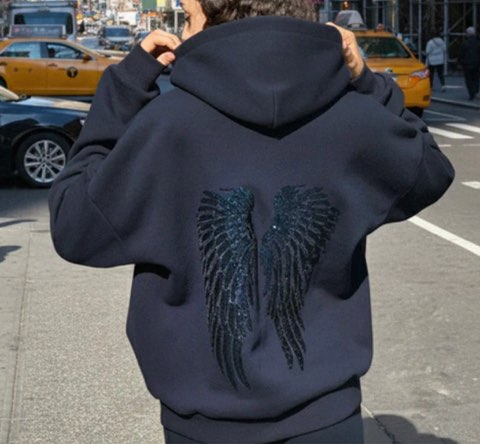 Heist Studio customer wearing the Angel Sequin Hoodie (Navy) on a city street