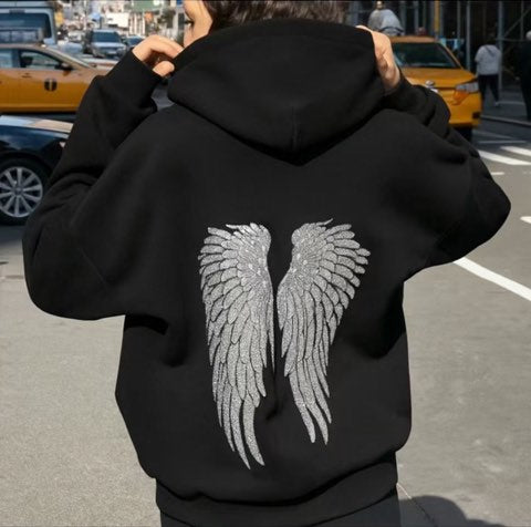 Heist Studio customer wearing the Angel Sequin Hoodie (Black) on a city street
