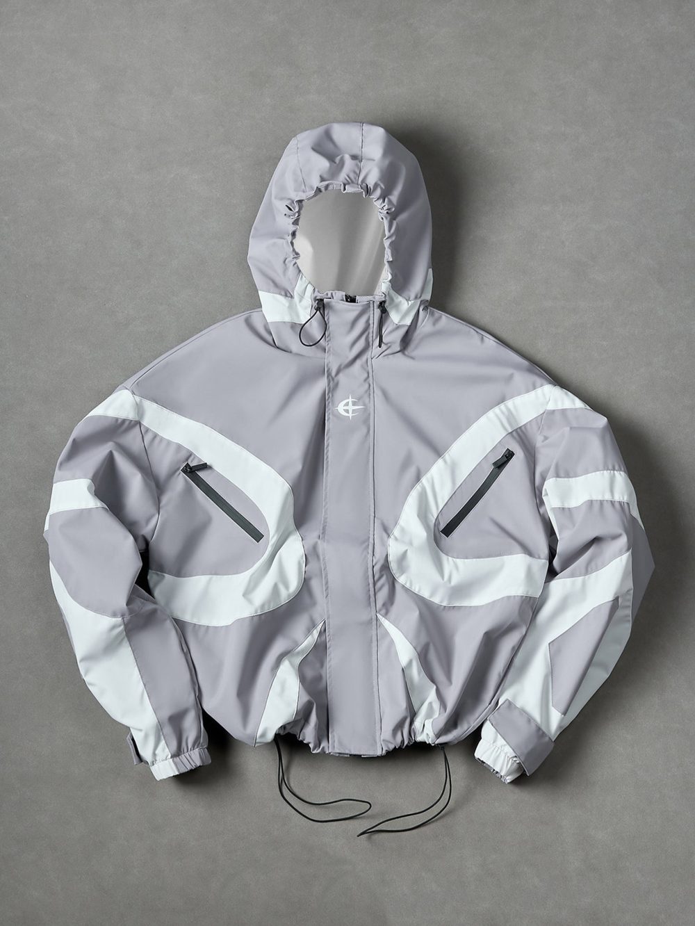 Silver windbreaker, swirl panels, black zip trim, drawcord hem