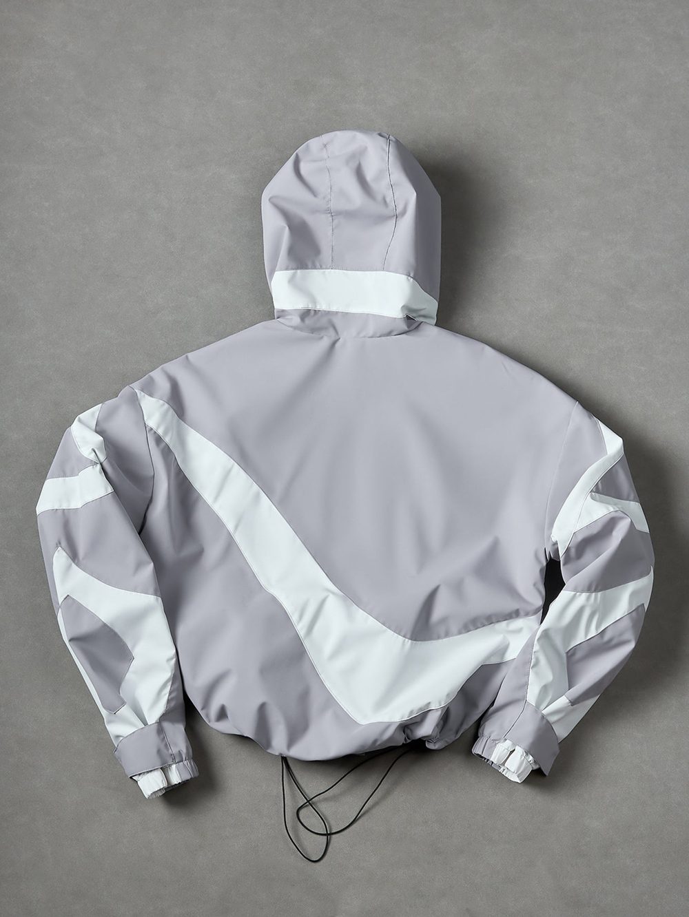 Silver windbreaker, back with the large swirl panel and the hood