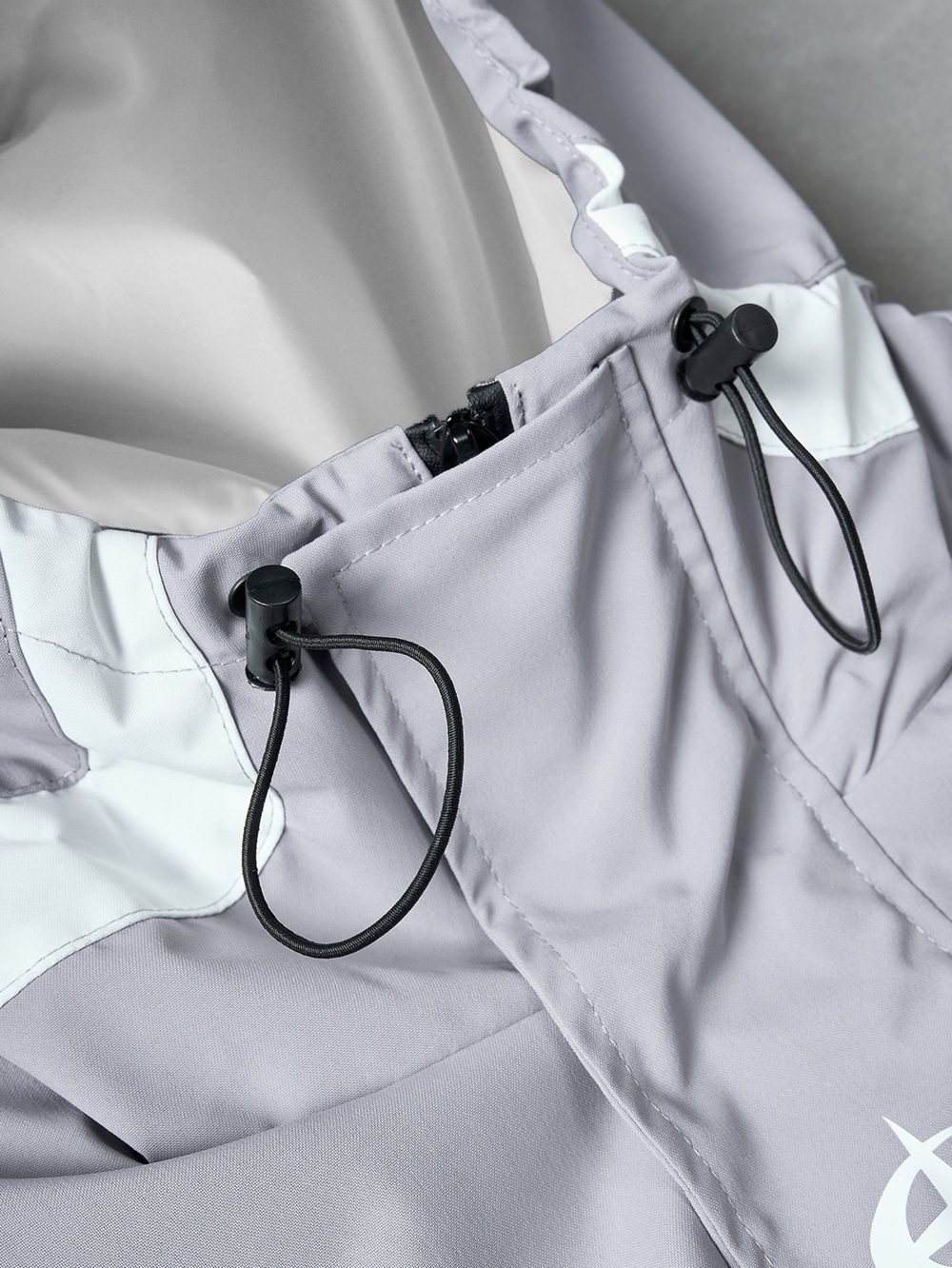 Silver windbreaker, hood with black drawcord and toggle